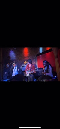 a group of people playing a musical instrument in a dark room